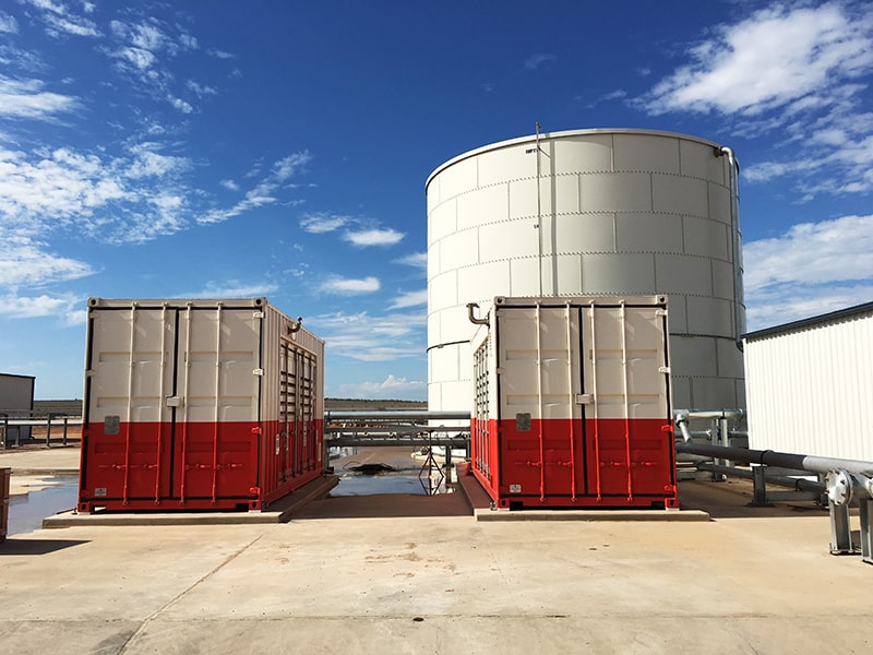 Two large containerised tanks, indicating a complex system for fluid transportation.