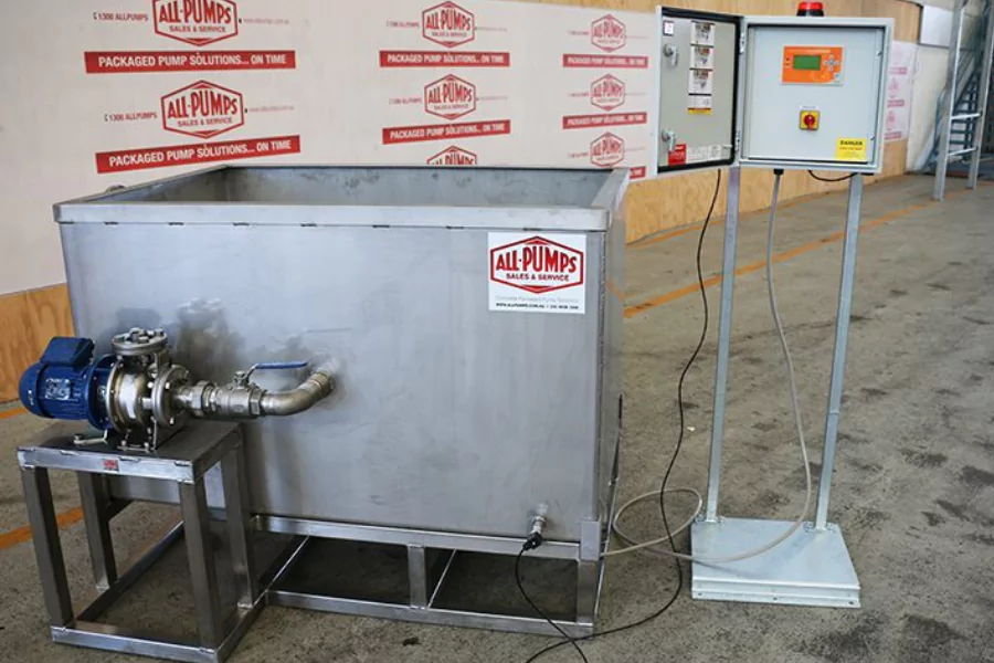 Metal testing tank system with an electric pump and control panel setup, branded with All-Pumps signage on a warehouse floor.