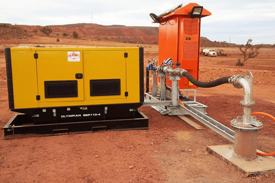 A yellow Pump station on a dirt road.