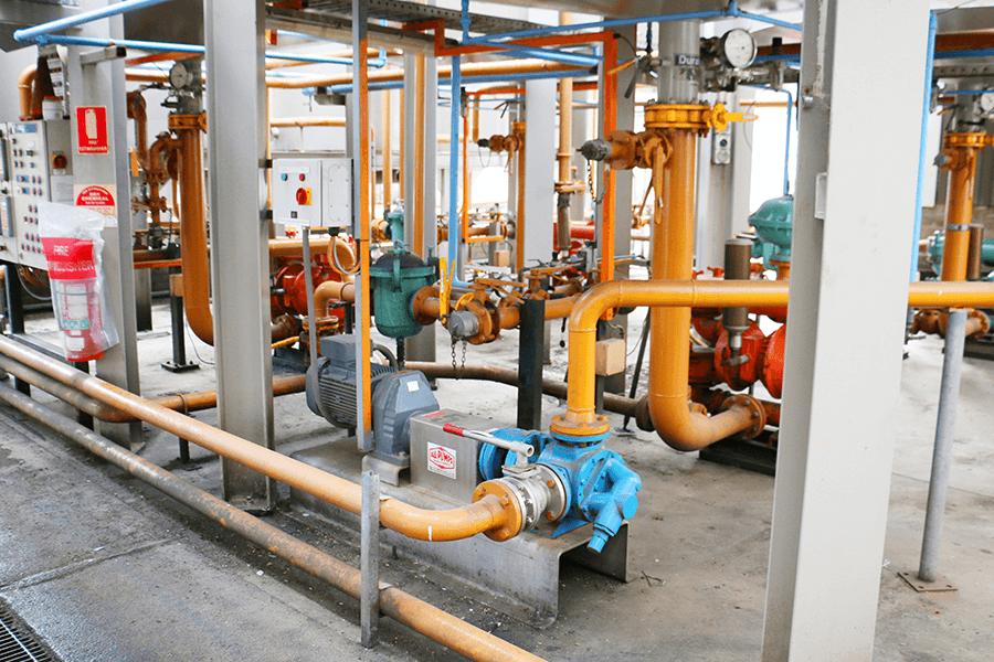 A room filled with pipes and valves, showcasing the intricate network of plumbing and control systems.