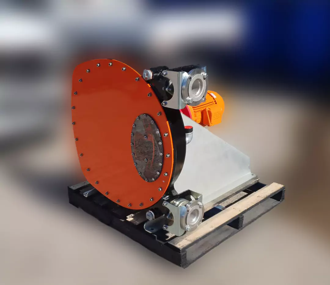 Large orange and grey Abaque hose pump (peristaltic pump) assembled on a skid, suitable for handling highly viscous and abrasive mining slurry and chemical transfer