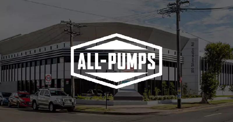 All-Pumps warehouse with black overlay and white logo