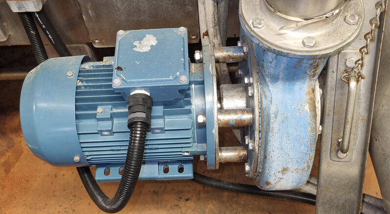 Close-up of a blue Ebara centrifugal pump with connected motor and flanged fittings in an industrial installation. Ideal for fluid circulation, cooling systems, and wastewater management in commercial and manufacturing environments.