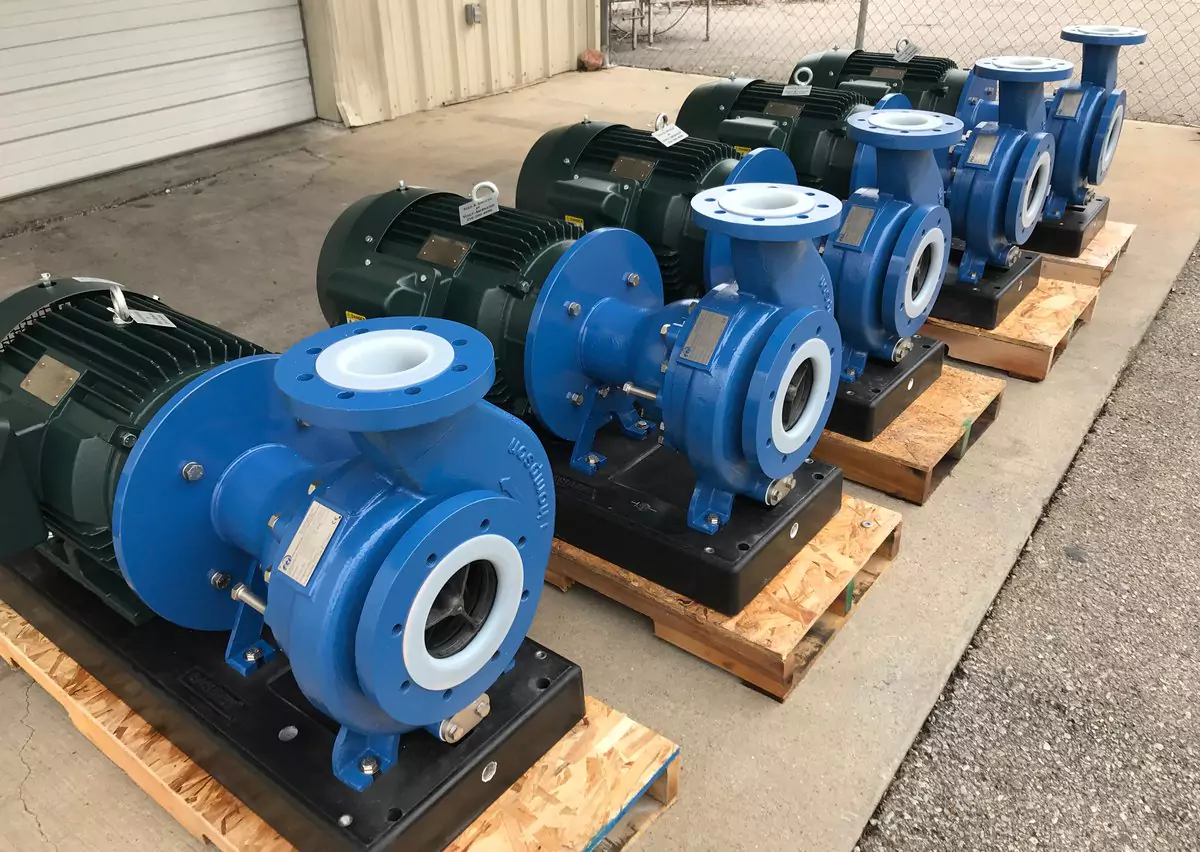 Line of blue Finish Thompson Inc. (FTI) centrifugal pumps with heavy-duty motors on wooden pallets. Engineered for high-efficiency chemical transfer and fluid handling in industrial and wastewater environments.