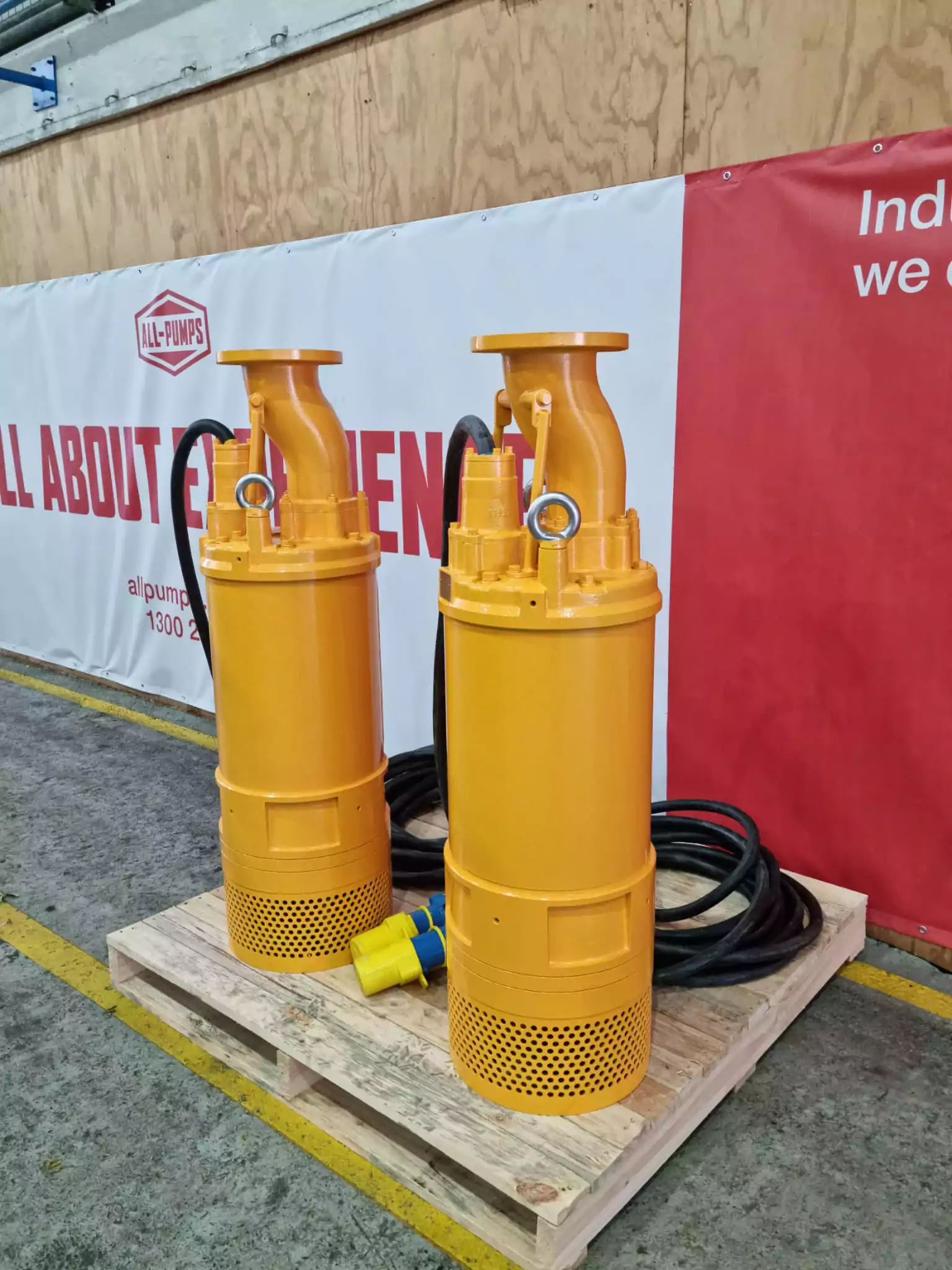 pair of yellow 1000 volt mine dewatering pumps on pallet