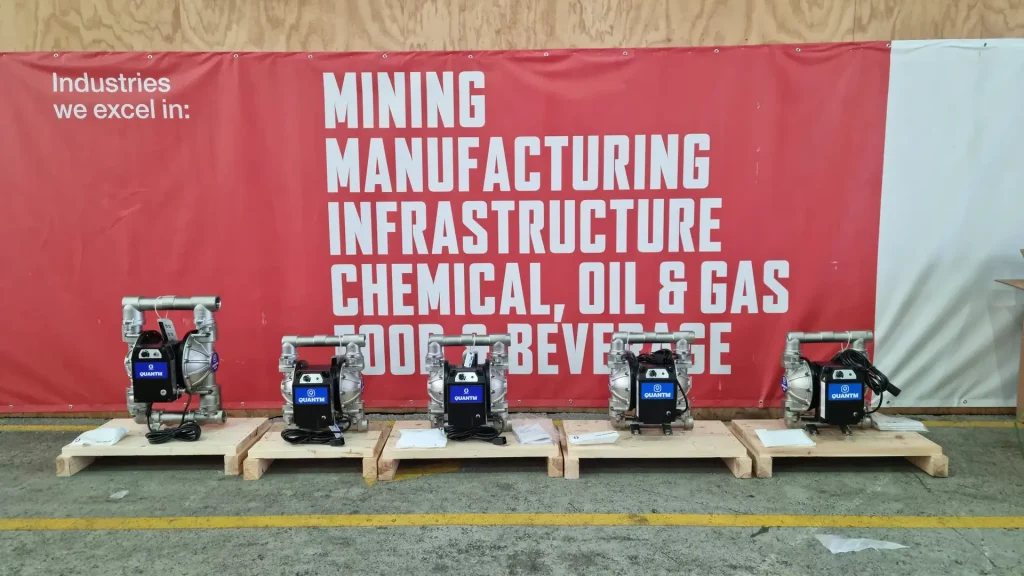 Multiple units of Graco QUANTM Electric Operated Double Diaphragm (EODD) pumps lined up on pallets, ready for deployment in mining, manufacturing, chemical, and oil & gas fluid handling industries
