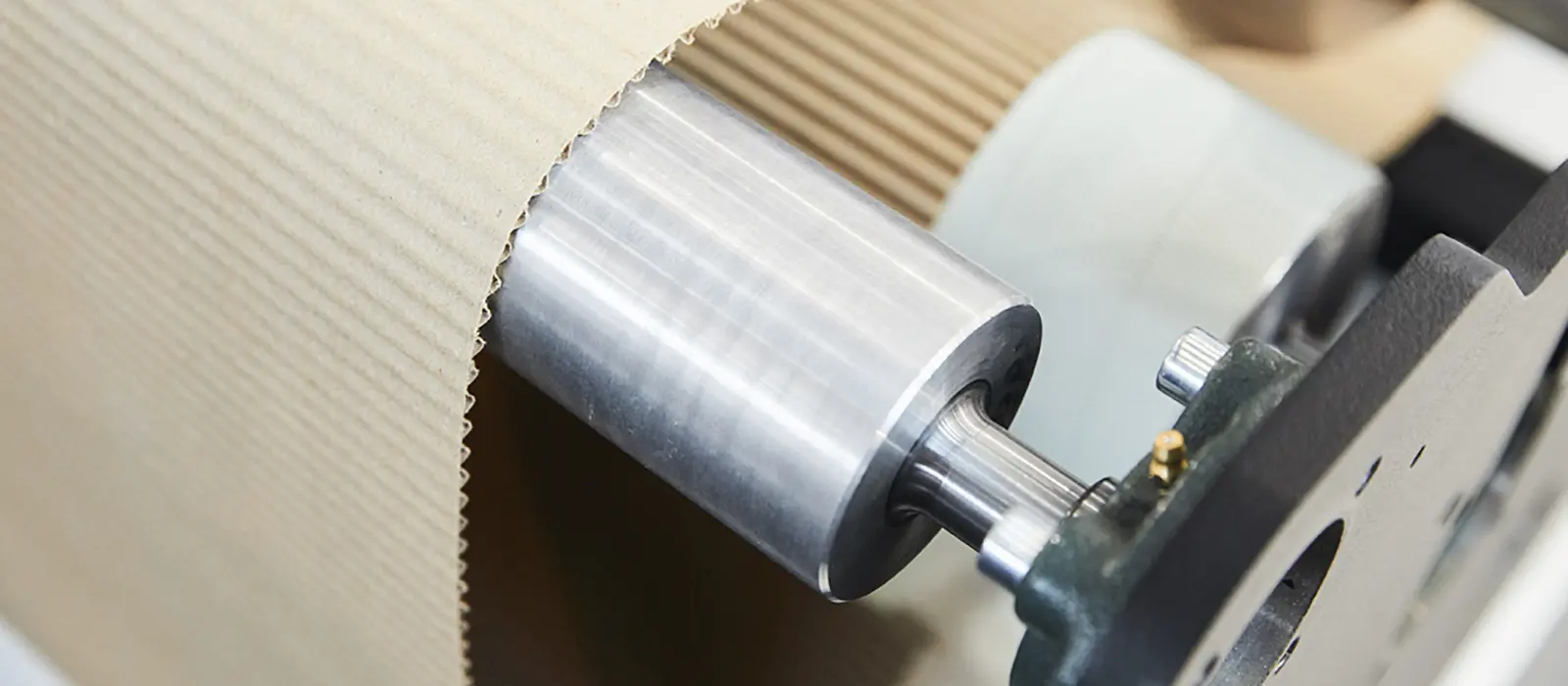 A machine is actively cutting sheets of paper into smaller pieces in a well-lit workspace