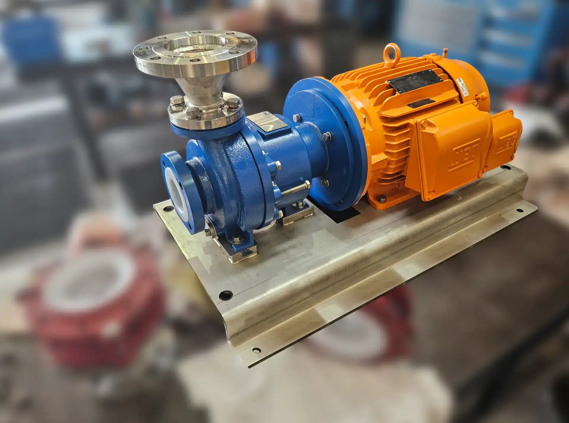 A tabletop FTI UC MAG DRIVE PUMP with a striking red and orange valve, highlighting its mechanical features and color contrast.