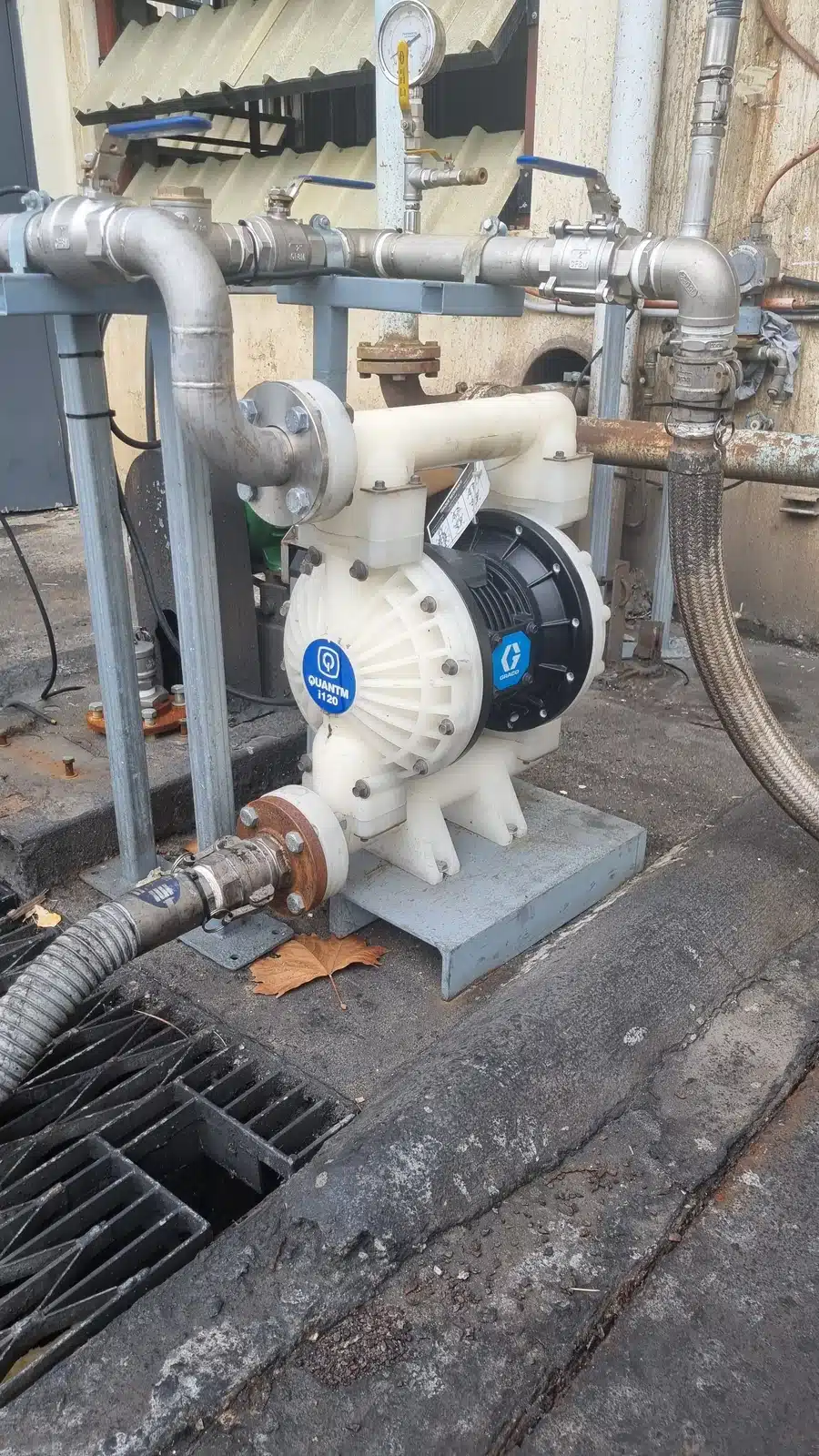 A Graco QUANTM AODD pump positioned on a concrete floor