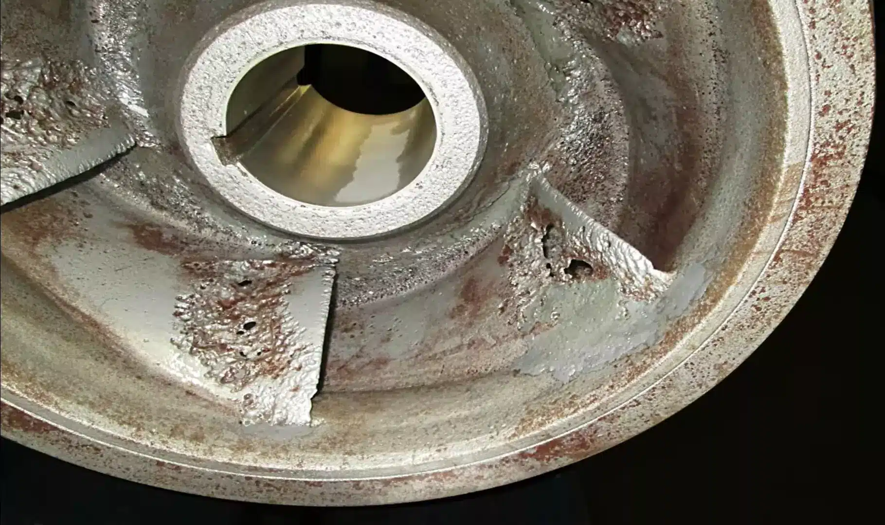Close-up of a rusted metal wheel, showcasing its weathered texture and aged appearance