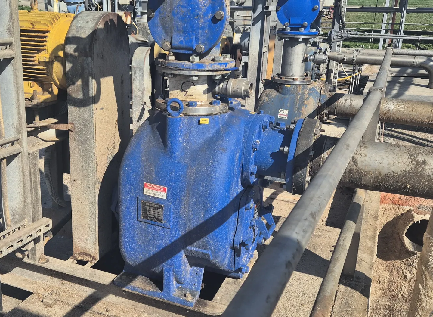 Industrial WSP self-priming trash pump with a blue casing and yellow WEG motor for solids handling.