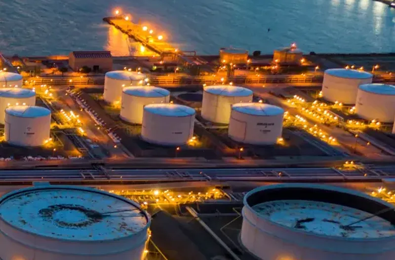 Oil and gas processing facility at dusk.