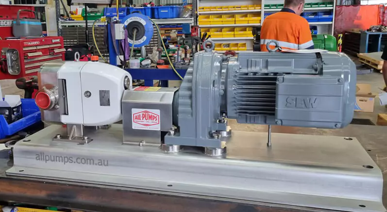 Large gray Packo rotary pump beside a motor