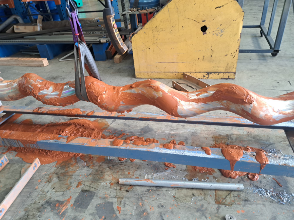 WANGEN screw conveyor rotor undergoing workshop maintenance and inspection before progressive cavity pump refurbishment.